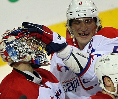 Alex Ovechkin (right) acknowledges goalie Michal Neuvirth, who stops 31 shots for his second shutout this season.  (AP)
