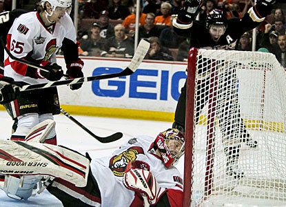 Lubomir Visnovsky (not shown) gets credit for the goal, but it's Erik Karlsson (65) who puts the puck into his goalie's net. (AP)
