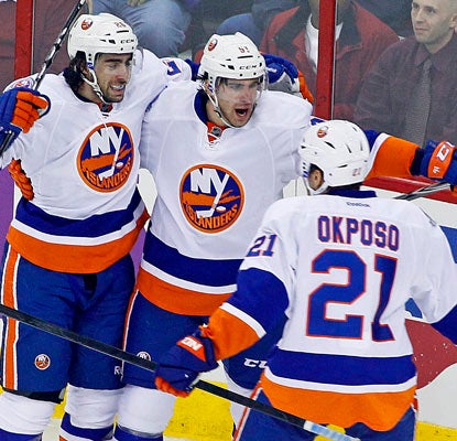 John Tavares (middle) notches four points for the Islanders with two goals and two assists.  (AP)
