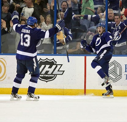 Steven Stamkos (left) celebrates his NHL-leading 33rd goal, which comes with 2:45 left in overtime to lift the Lightning.  (US Presswire)