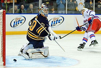 Ryan Callahan slides the puck past Ryan Miller for the only goal that counts on the scoreboard. (US Presswire)