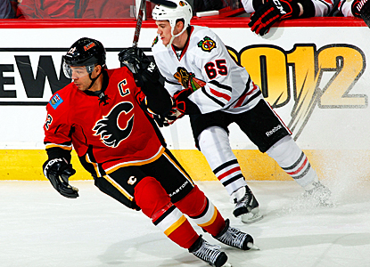 The Flames' Jarome Iginla skates around Andrew Shaw of the Blackhawks during the second period. (Getty Images)