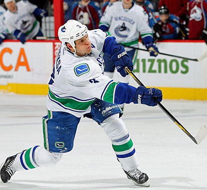 Kevin Bieksa powers a shot past Jean-Sebastien Giguere with 34 seconds remaining to tie the game. (Getty Images)