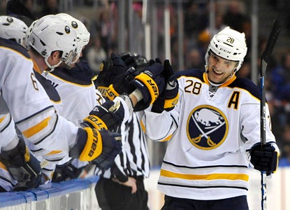 Buffalo's Paul Gaustad celebrates with teammates after his goal ties the score at 3-all and sends the game to overtime. (AP)