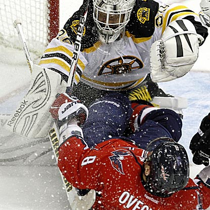 Tim Thomas keeps almost everything out Boston's net, including crease-crashing Alex Ovechkin.  (AP)