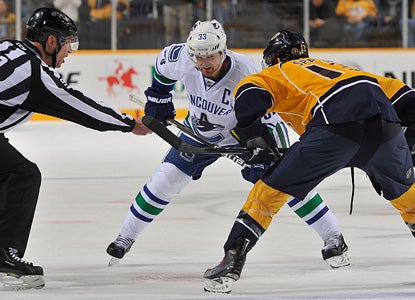 Henrik Sedin faces off here against the Preds' Nick Spaling.  Sedin contributes two assists in the shootout win. (Getty Images)
