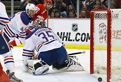 Edmonton's Corey Potter and Nikolai Khabibulin react late as Henrik Zetterberg's shot trickles in the net. (US Presswire)