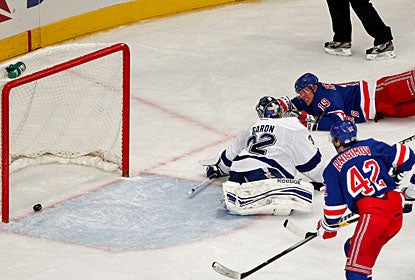 Brad Richards nets the winner after lunging for the puck and pushing it in the net while down on the ice. (US Presswire)