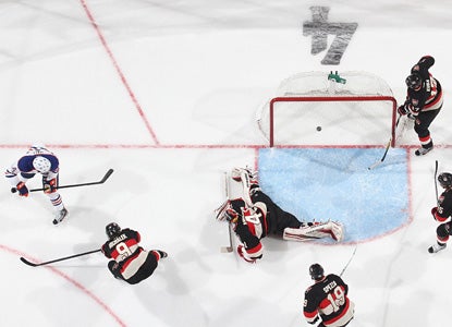 Taylor Hall (left) only needs 17 seconds of the overtime session to get the Oilers the win and snap a two-game losing streak. (Getty Images)