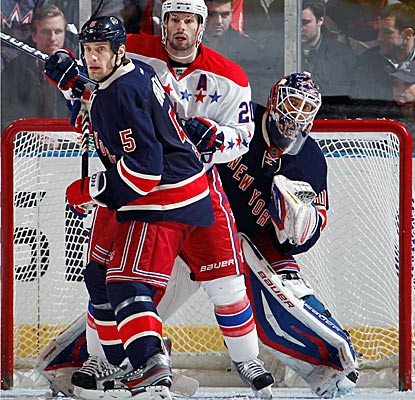 Henrik Lundqvist (30) finds his crease crowded with Dan Girardi (5) and Troy Brouwer (20) battling for position.  (Getty Images)