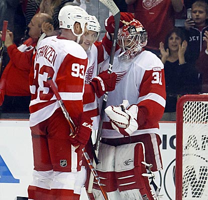 Red Wings goalie Joey MacDonald is congratulated after he holds tight against the Flyers' last push.  (US Presswire)