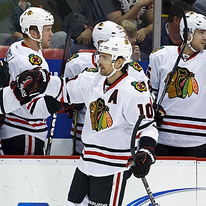Patrick Sharp scores one goal and assists on the other in the Blackhawks' win against the Red Wings. (US Presswire)