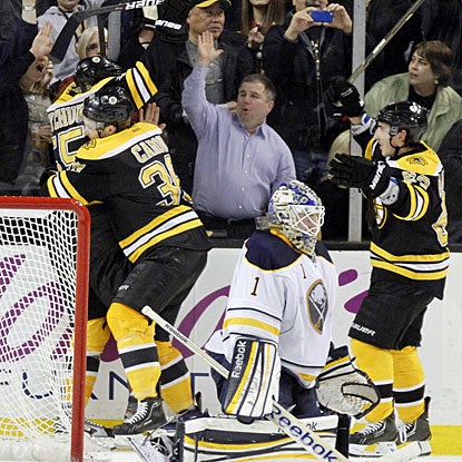 Jordan Caron (38) jumps all over Johnny Boychuk who breaks a 1-1 tie in the later stages of the third period. (AP)