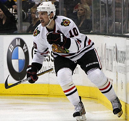 Patrick Sharp scores goals at almost identical times early in the first and third periods. (AP)