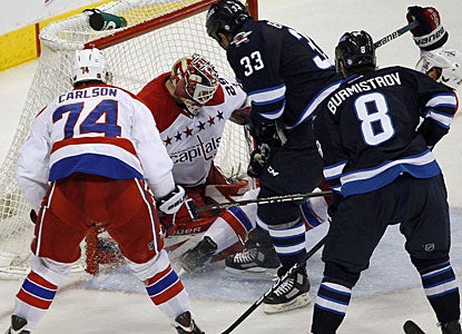 Dustin Byfuglien crashes the net and forces the puck past Tomas Vokoun for what turns out to be the winning goal. (AP)