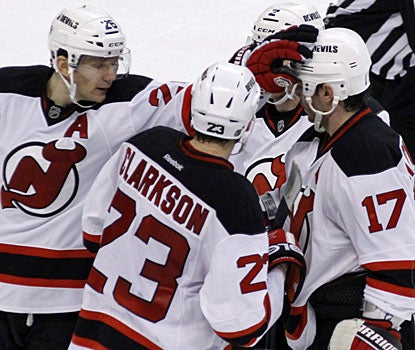 Ilya Kovalchuk (17) is cheered on by teammates for his 400th goal. He needs just 24 more to also reach the 400 assist mark. (AP)