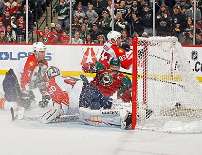 Mikko Koivu (9) beats former teammate Jose Theodore in overtime after spliting two Panthers defenders. (Getty Images)