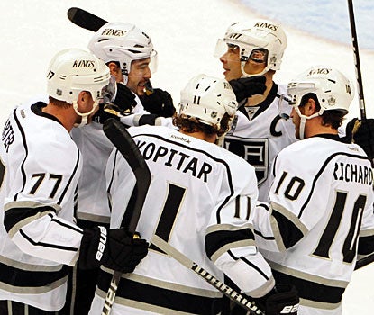 Kings players celebrate their big win after Dustin Penner scores with just over three minutes to play. (US Presswire)