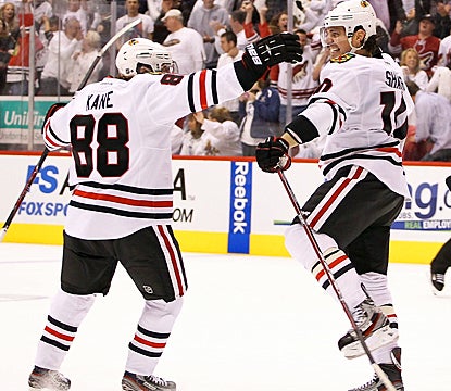 Patrick Sharp (right) celebrates with Patrick Kane after scoring the game-tying goal with just 5.5 seconds left in regulation. (Getty Images)