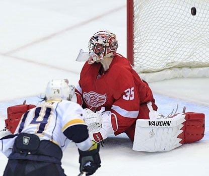Sergei Kostitsyn scores the game-clinching goal, beating Wings goalie Jimmy Howard late in the third period.  (AP)