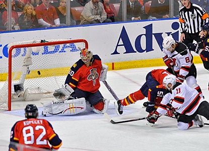 Stephen Gionta (11) is able to beat Jose Theodore with a backhander for New Jersey's second goal. (US Presswire)