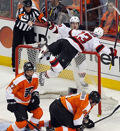 David Clarkson (23) is on top of the net, which is knocked off its moorings after he scores the winning goal. (AP)