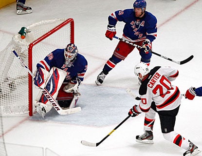 Ryan Carter beats Henrik Lundqvist after just coming off the bench for a line change. (US Presswire)