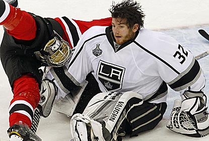 Kings goalie Jonathan Quick, who is once again brilliant in net, loses his mask in an overtime collision.  (US Presswire)