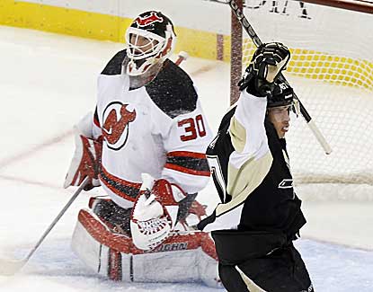 Sidney Crosby gets one past Devils goalie Martin Brodeur to lead the Pens to their first home victory of the season. (AP)