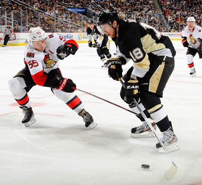 James Neal (right), who scores a pair of goals against the Senators, battles Sergei Gonchar for the puck. (Getty Images)