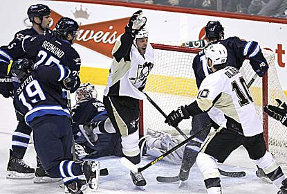 Pittsburgh's Craig Adams scores two goals, including an empty-netter in the final moments, to help Pittsburgh drop Winnipeg. (AP)
