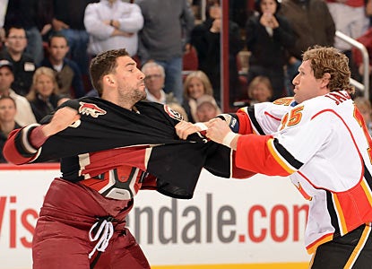Paul Bissonnette of the Coyotes gets into some extracurricular action on the ice with Tim Jackman. (Getty Images)