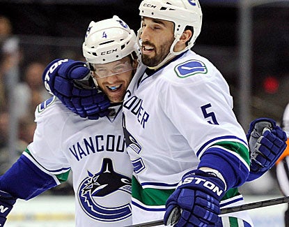 Vancouver's Jason Garrison scores a 3rd-period goal and celebrates with defenseman Keith Ballard. (USATSI) 