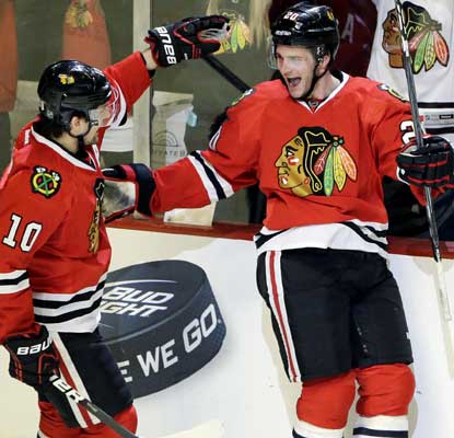 Brandon Saad scores a short-handed goal to snap a 1-1 tie and send the Hawks into the record books.  (AP)
