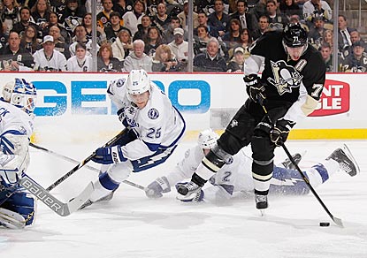 Evgeni Malkin skates cross-ice between two Lightning defenders before scoring the tying goal in the third period.  (Getty Images)