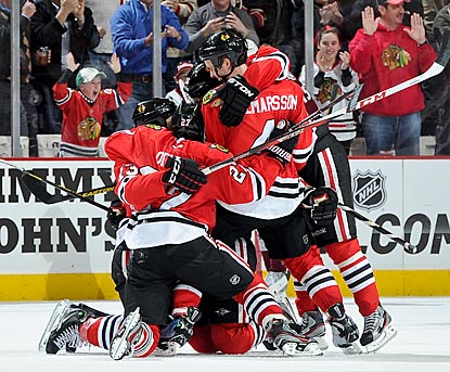 Daniel Carcillo (left) celebrates with teammates after giving Chicago its first lead of the game in the final minute.  (Getty Images)