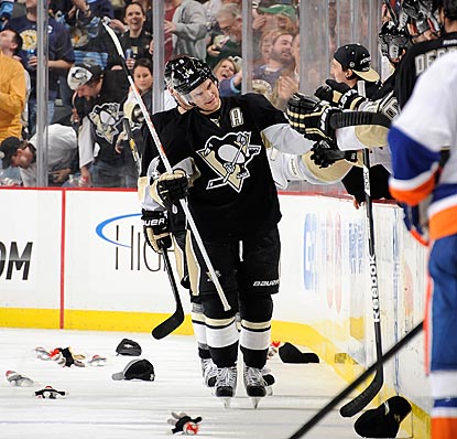 Amid a littering of sock monkeys, Chris Kunitz accepts congratulations upon completion of his second hat trick of the season.  (Getty Images)