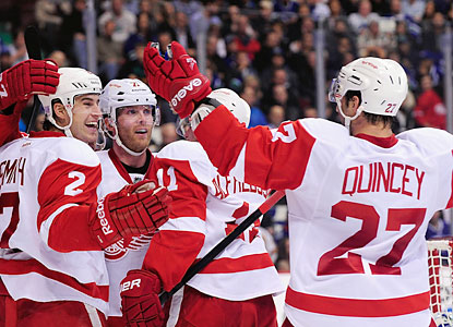Daniel Alfredsson (11) celebrates with Brendan Smith (2) and Kyle Quincey (27) after scoring his goal. (USATSI)