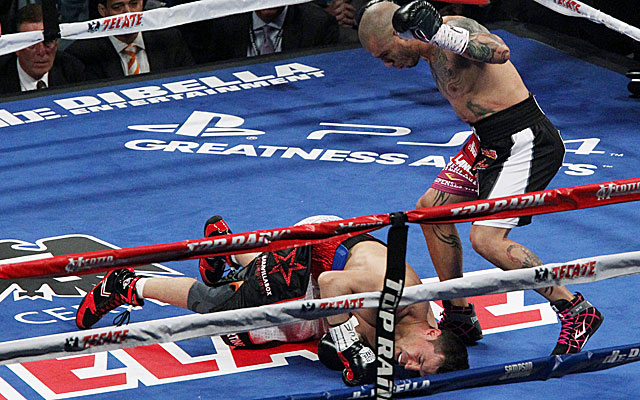 Miguel Cotto knocks down Sergio Martinez in the first round en route to improving to 39-4. (USATSI)
