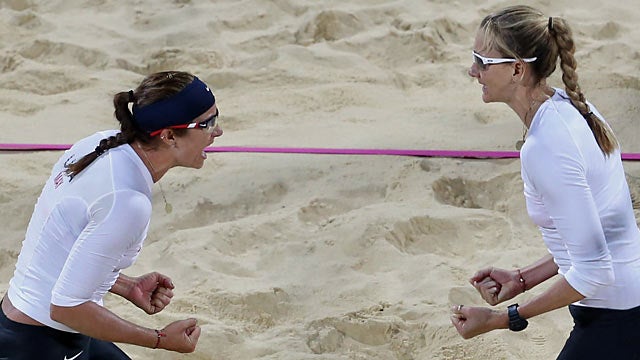Misty May-Treanor and Kerri Walsh Jennings celebrate their 16th straight Olympics win. (AP)