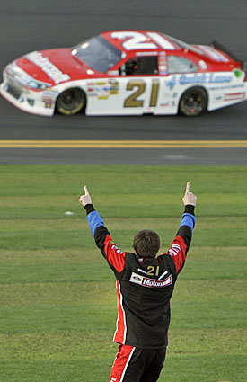 A member of Trevor Bayne's pit crew celebrates while the No. 21 takes a victory lap. (AP)
