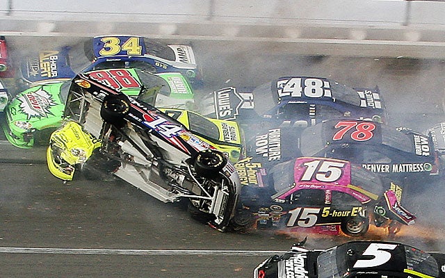 Tony Stewart (14) flips over during a crash on the final lap on Sunday. (AP)
