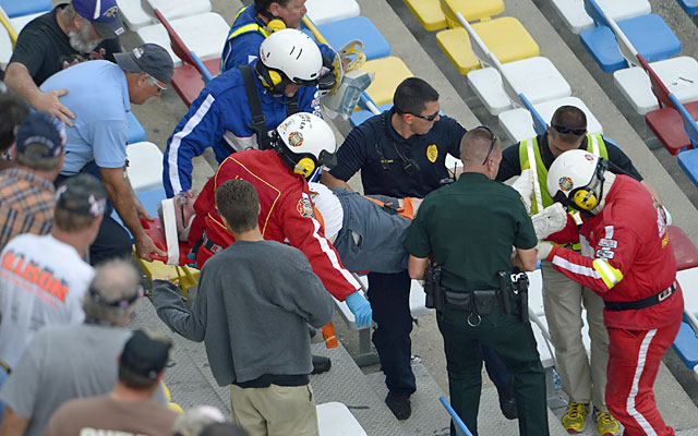 Emergency officials transport a spectator injured from a frightful last-lap accident. (AP)