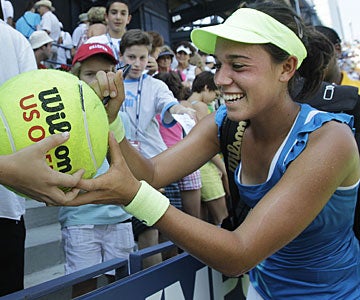 Beatrice Capra is happy to oblige her fans with autographs after her fine victory. (AP)
