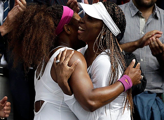Serena gets a hug from sister Venus. The two now own 10 Wimbledon singles titles between them. (AP)