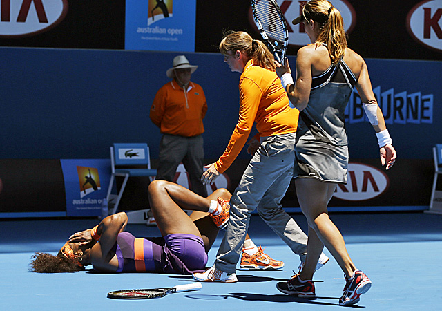 Chair umpire Kerrilyn Cramer (center) and Edina Gallovits-Hall come to the aid of Serena Williams. (US Presswire)