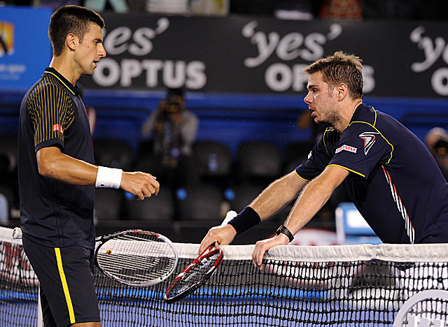 A worn-out Stanislas Wawrinka congratulates Djokovic on winning their epic five-setter. (AP)