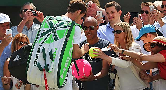 Andy Murray signs autographs after dispatching Blaz Rola. (Getty Images)
