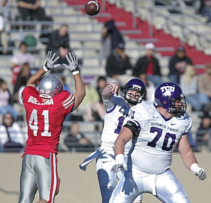 TCU quarterback Andy Dalton passes over New Mexico linebacker Dallas Bollema as Zack Roth (70) looks to block. (AP)
