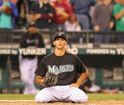 Florida's Steve Cishek sits helplessly at home plate after his wild pitch plates the winning run. (Getty Images)